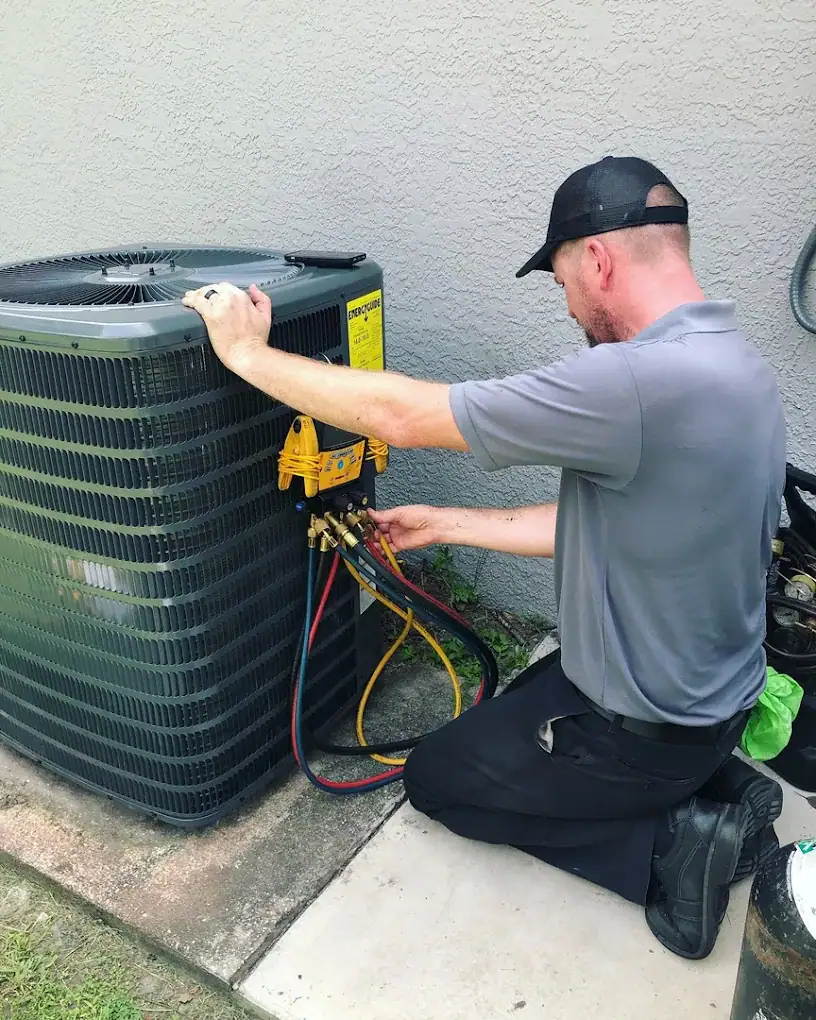 Comfort Authority technician checking refrigerant pressures on an outdoor AC unit