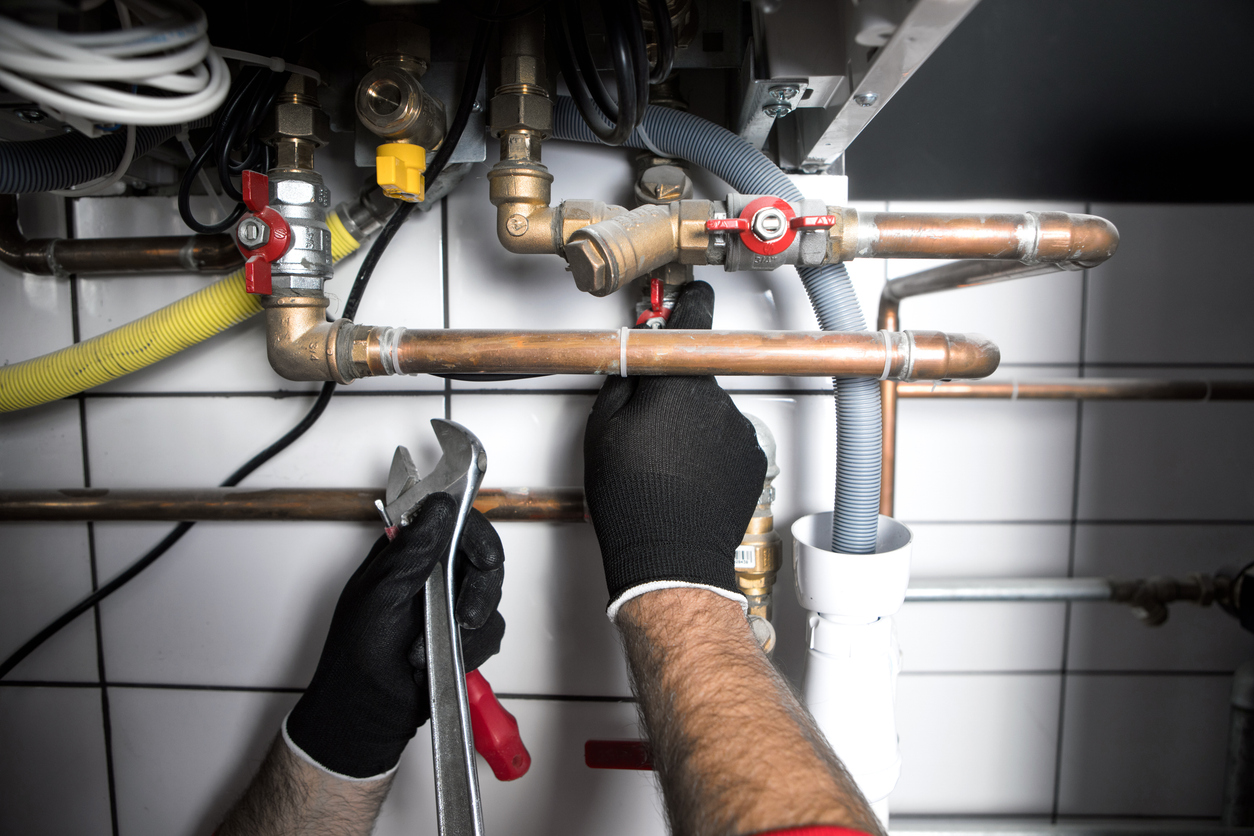 Plumber with Wrench and Pipes
