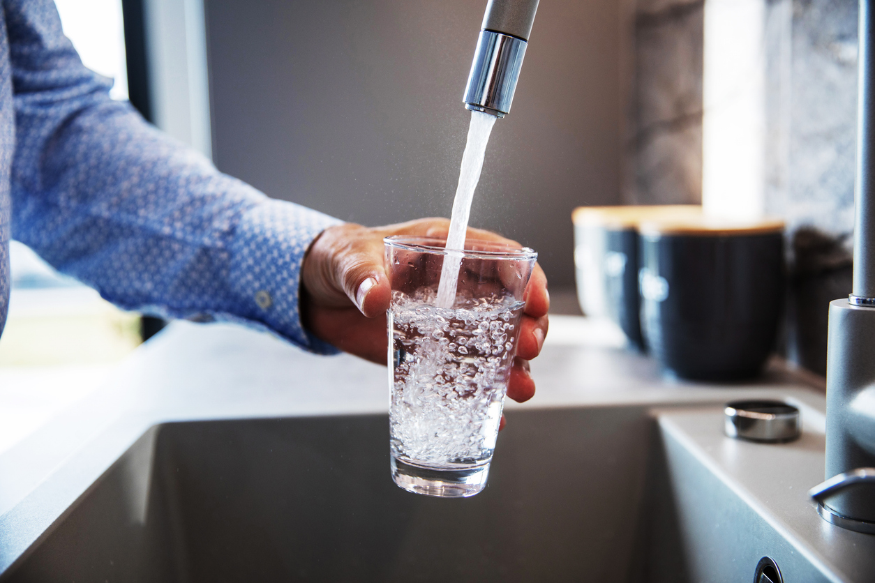 Man Pouring Water in Glass