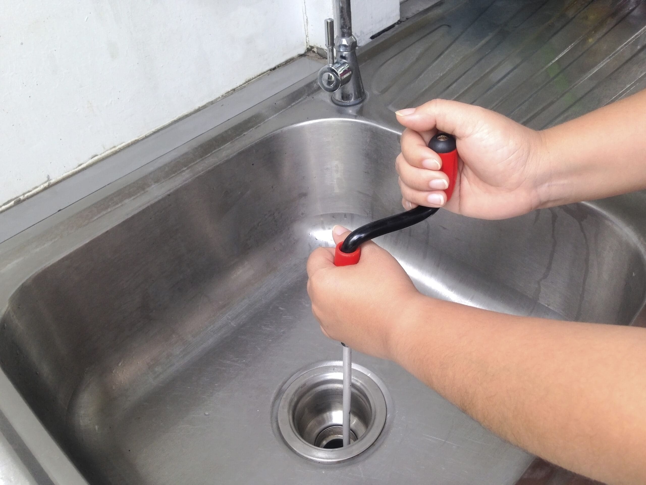 Plumber Unclogging Drain