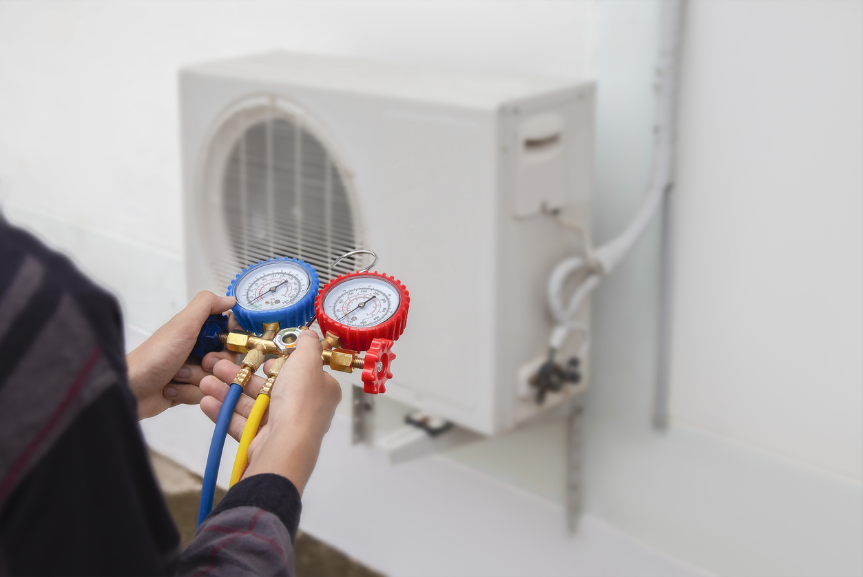 AC Service Technician in Brandon Using Gauges