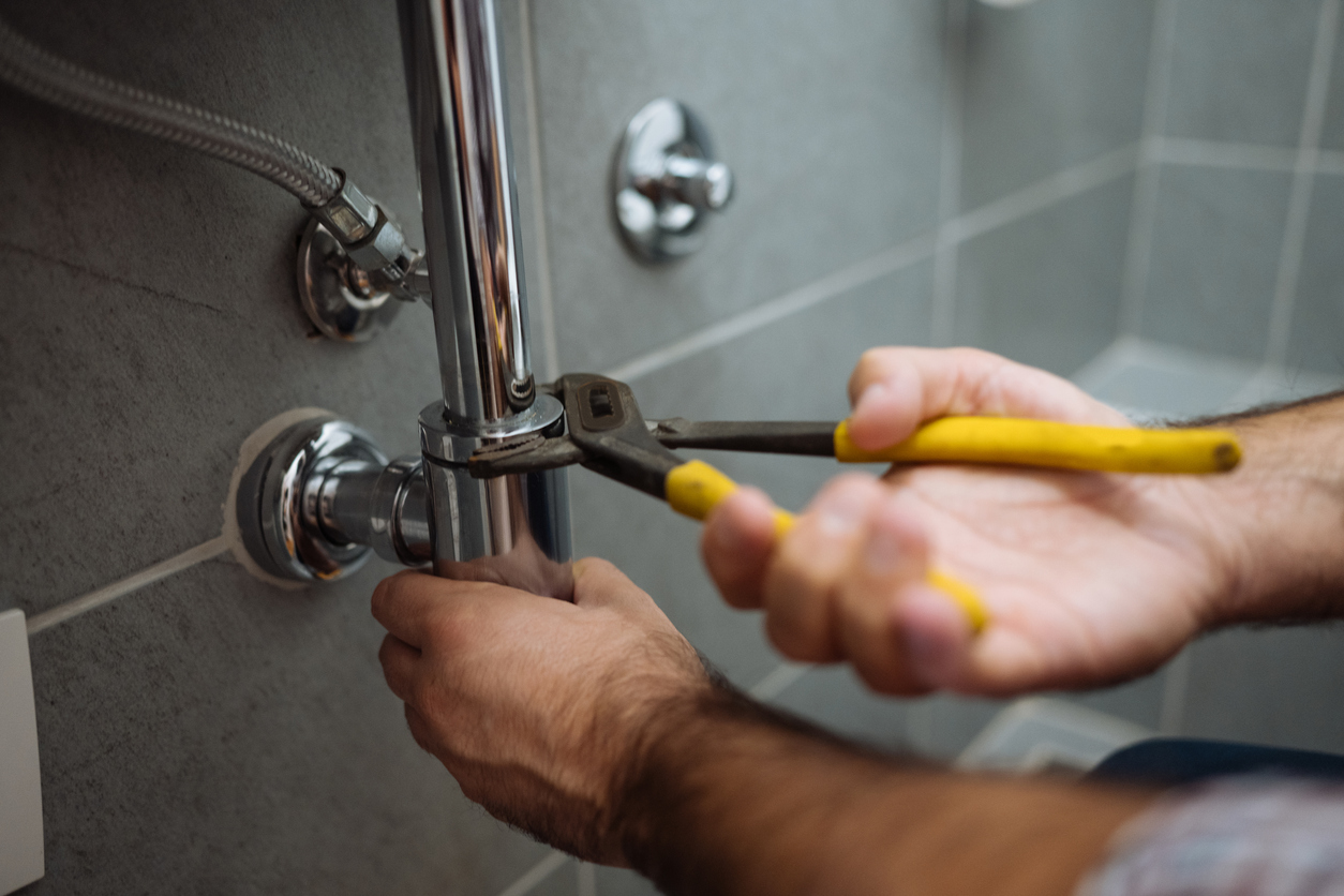 plumber fixing bathroom pipe