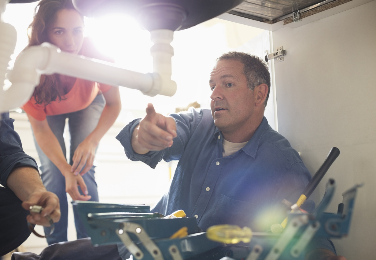 Friendly Plumber Fixing Sink